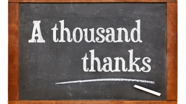 A graphic of a wood framed blackboard showing the words, "A thousand thanks" in white chalk.